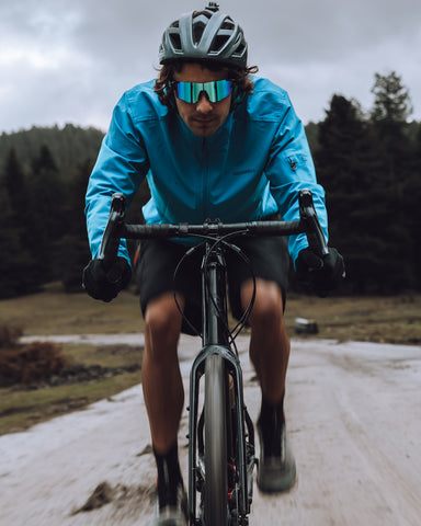 a male cyclist cycling on the road wearing Torege sports sunglasses