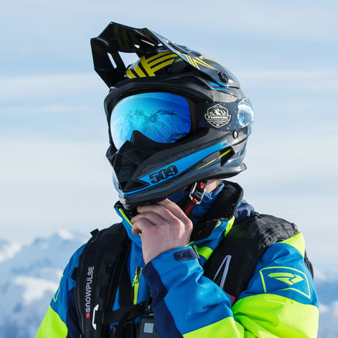 a skier standing on a snow mountain wearing Torege snow goggles